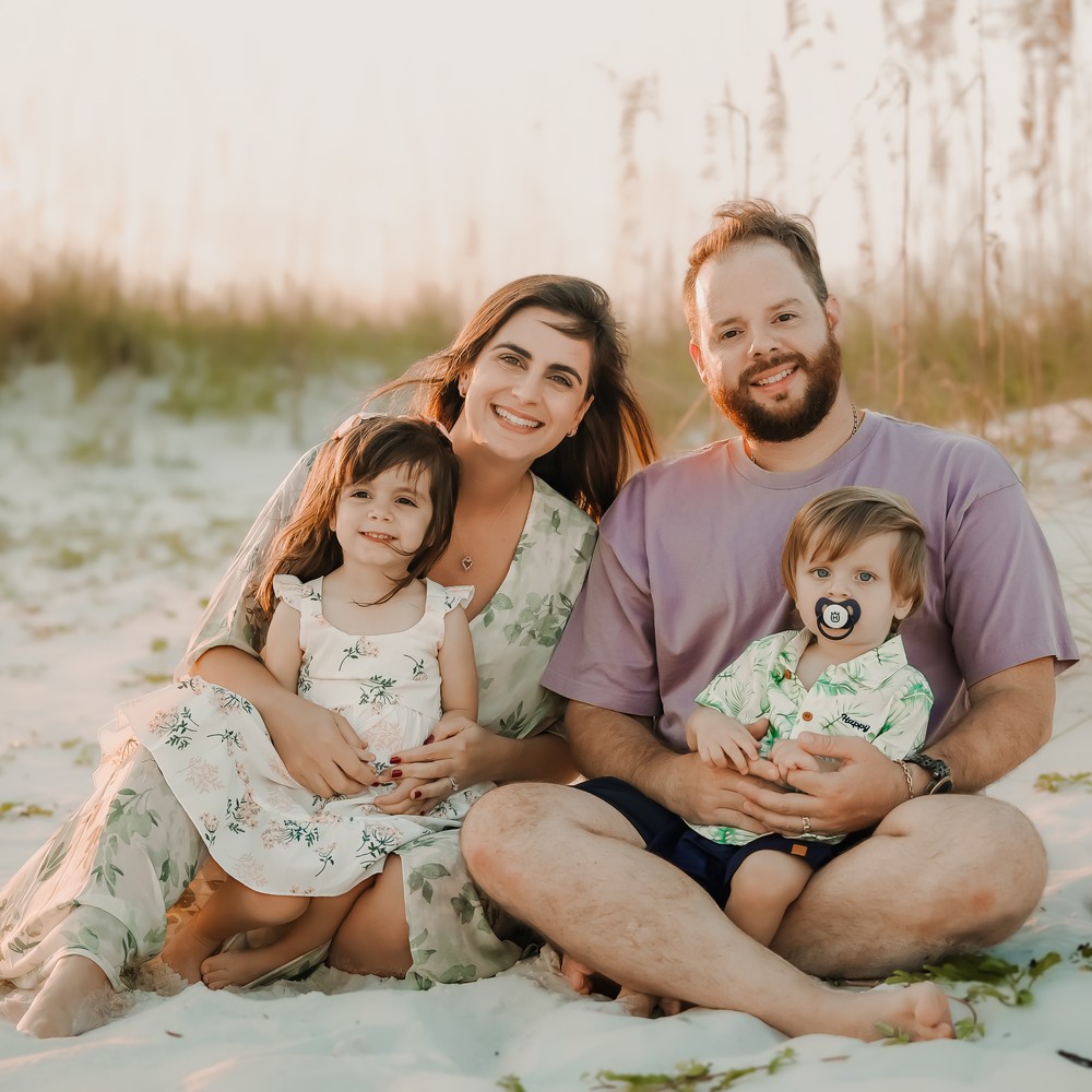 Luiza and family on the beach at sunset