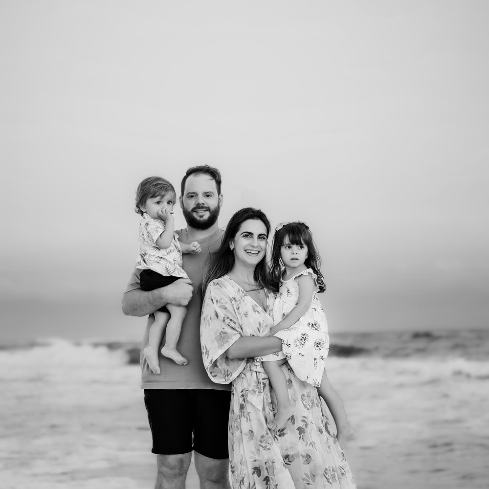 Luiza and family standing at the shoreline